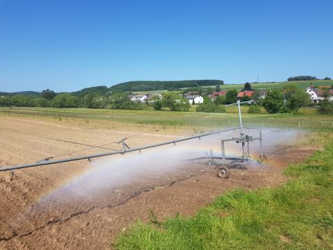 Die Bewässerungsmaschine lässt einen Regenbogen entstehen.